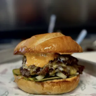 Smashburger, house pickles, grilled onion, three cheese, special sauce.
