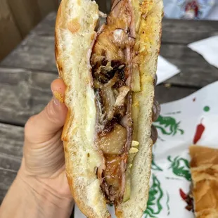 a hand holding a sandwich