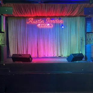 a stage with a neon sign