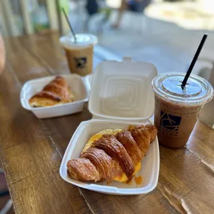 a croissant and iced coffee on a table