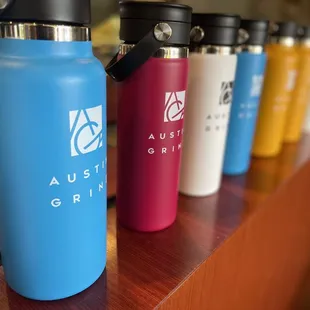a row of colorful stainless steel water bottles
