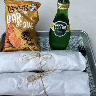 a tray of food and a bottle of beer