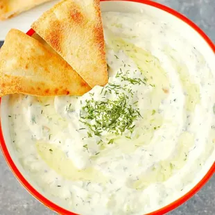  a bowl of dip with pita chips