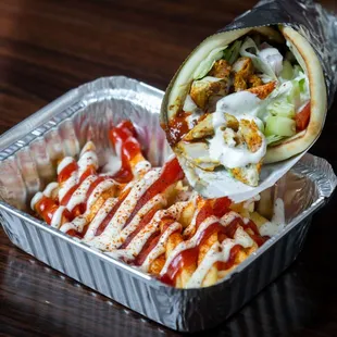  a burrito in a foil container