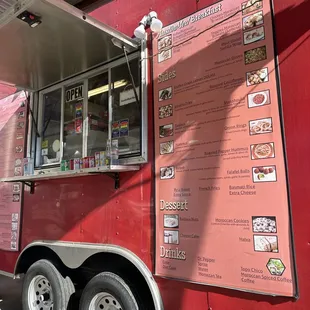 a red food truck with menus