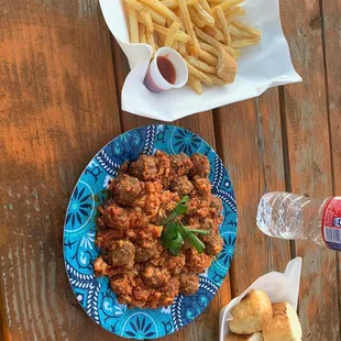 a plate of meatballs and french fries