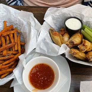 Chicken wings with sweet Thai sauce on the side plus sweet potato fries