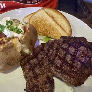 12 oz Ribeye with fully loaded potato plus one more side not pictured