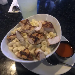 Macaroni and cheese with chicken and a side of Buffalo sauce