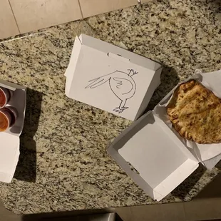 a slice of pizza in a box and a slice of pizza in a box