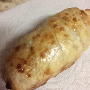 Hair sticking through the pizza roll in 2 different spots.