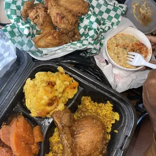 a tray of chicken, rice, and corn