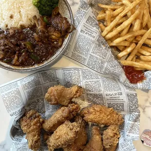 a plate of fried chicken and french fries