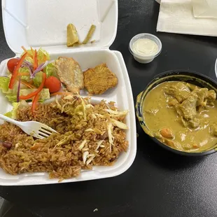 Goat curry, rice with spicy cabbage mixed in, side salad and plantain.