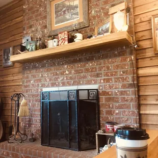 a brick fireplace in a rustic living room