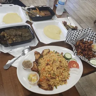 Fufu, palavar (dark green), pepper soup (orange) with more fufu, jollaf rice, and fried plantains.