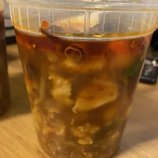 a plastic cup of soup