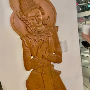 a woman taking a picture of a statue