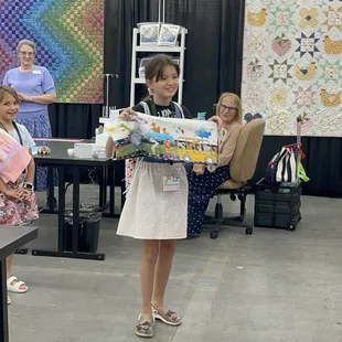 My daughter is showing everybody what she made an apron, a pillowcase, a scrunchie