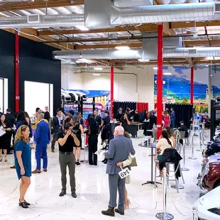 Networking with a twist inside Auto Vino's grand showroom - where business meets luxury.