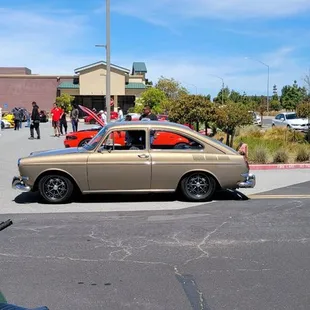 a classic car parked in a parking lot
