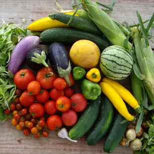 a variety of vegetables on a wooden table