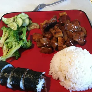 a red plate with rice, broccoli, and meat