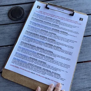 a hand holding a clipboard with a list on it