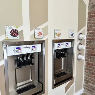 two coffee machines on a wall