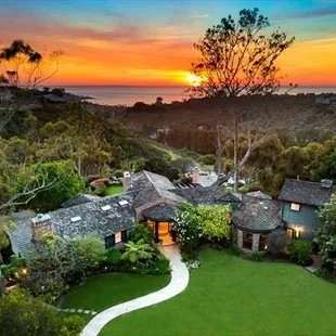 an aerial view of a home at sunset