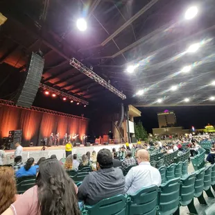a stage with people sitting in chairs
