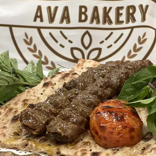 a piece of bread with meat and vegetables