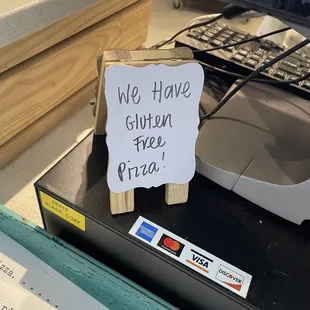 a sign that says we have gluten free pizza
