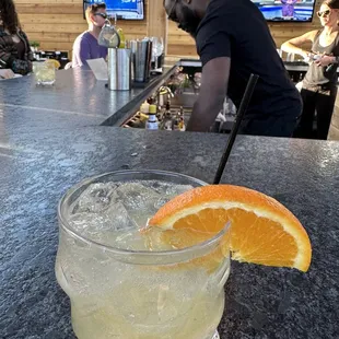 a glass of lemonade with a slice of orange