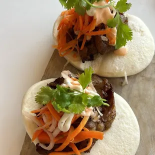 two tacos on a cutting board