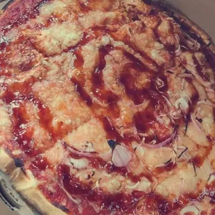 Large pizza with Vegan cheese, onions on half and a BBQ drizzle.