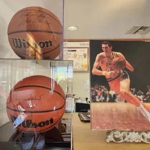 Basketball memorabilia signed by hoops Legends John Wooden and Jerry "The Logo" West!