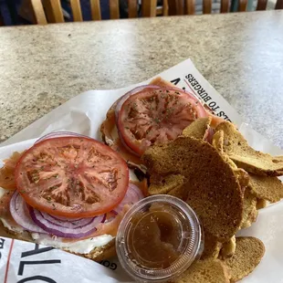 $10 LOX BAGEL w/ CHIVE CREAM CHEESE, RED ONION, TOMATO on a CHEESE BAGEL - delicious! Thin sliced red onions, yay!