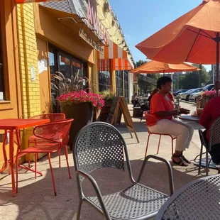 a woman sitting at an outdoor cafe