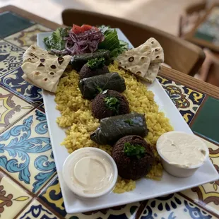 Vegan Platter is still amazing and filling AF - Falafel, Grape Leaves, Rice, Salad, Tahini, Hummus and Pita