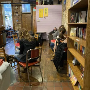 people sitting in chairs in a library