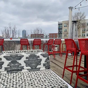 a patio with red chairs