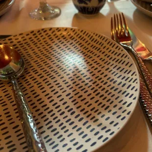 a plate with a spoon and fork on it
