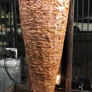 a large kebab being cooked