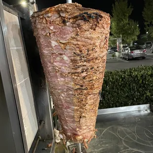 a kebab being cooked on a skewer