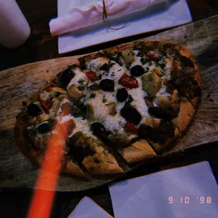 a pizza on a cutting board