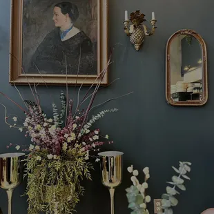 a vase of flowers and candles on a table