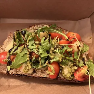 a slice of bread topped with vegetables