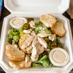 Caesar salad with added grilled chicken, peppers