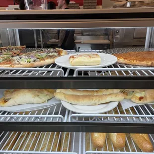 Pizzas, strombolis, bread